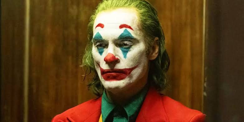 In Joker, color gradually shifts from cold, dim tones to warmer, intense hues as Arthur Fleck transforms into the Joker. color theory in filmmaking