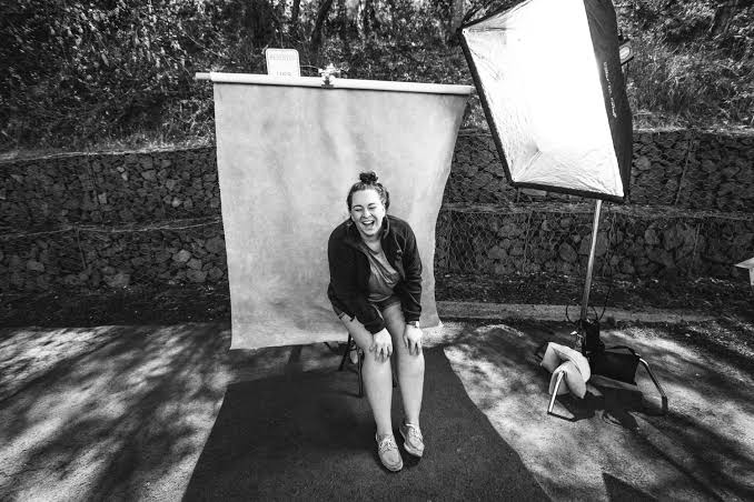 Crew using bounce board during outdoor daylight film shoot