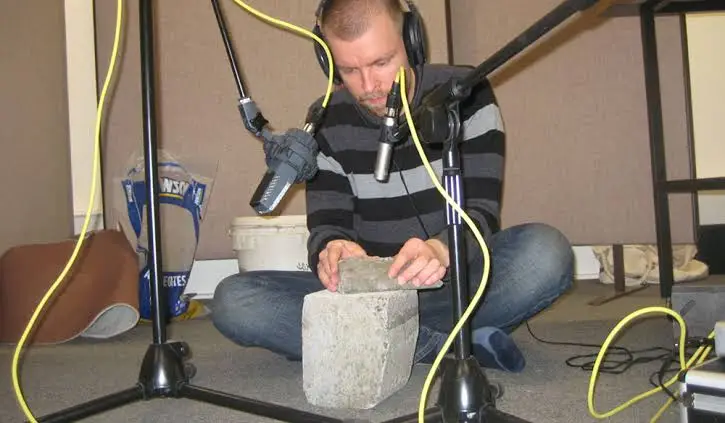 Sound designer working on audio tracks for a film using mixing software