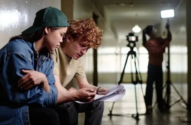 Film in development two boys discussing screenplay of a film