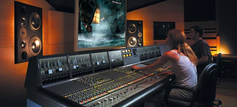 Film post-production crew mixing sound for final movie cut