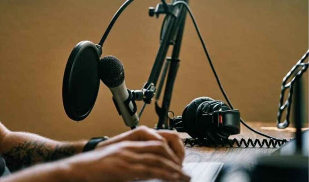 Actor recording Automated Dialogue Replacement (ADR) in a studio, syncing dialogue with video playback for filmmakers.