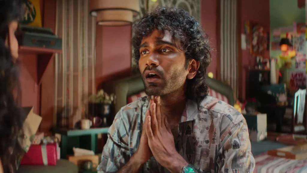 Pradeep Ranganathan with a worried expression and clasped hands in a comedic scene from the Dude 2025 film screenplay.