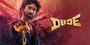 Official promotional poster for the Dude 2025 film showing an intense Pradeep Ranganathan holding a yellow sacred thread against a red background.