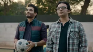 The Real Kashmir Football Club coach holding a football on the training ground, looking optimistic, illustrating the resilience themes discussed in this Real Kashmir Football Club review.