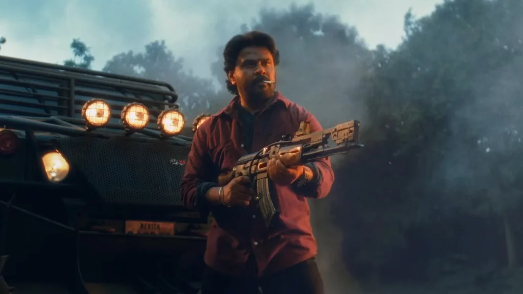 Bha Bha Ba 2025 movie intense action scene featuring a rugged character holding a gun during a high-voltage sequence
