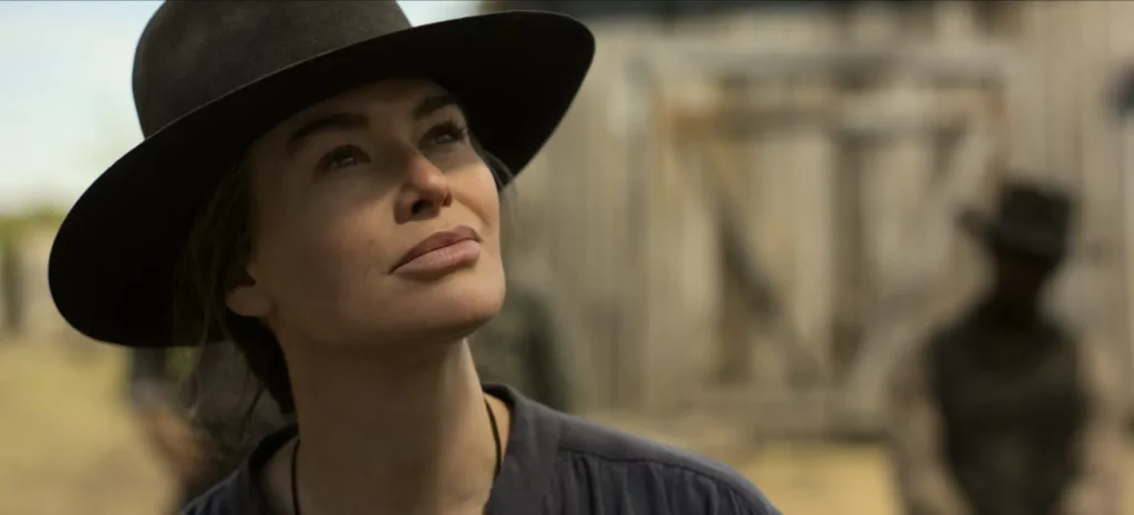 A close-up of Lena Headey as Fiona Nolan looking resilient under the sunlight in a scene from The Abandons Netflix series.