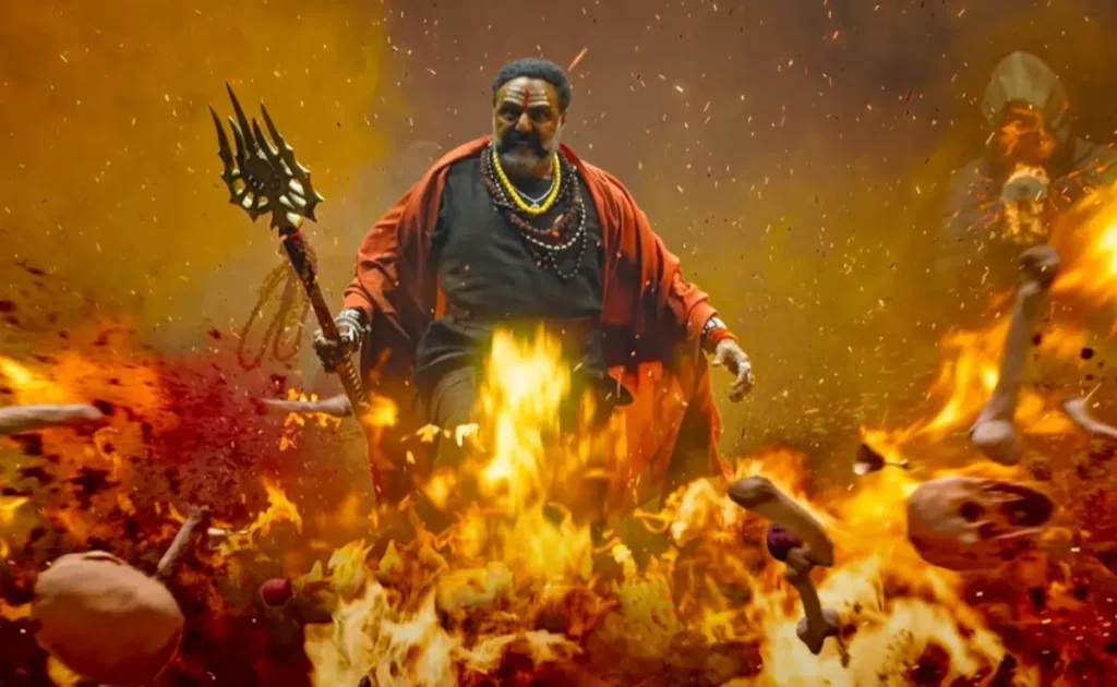 Nandamuri Balakrishna in a fierce avatar walking through massive flames holding a trident in Akhanda 2: Thandavam.