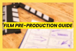 Film Pre-Production Guide header image featuring a blurred film clapperboard and storyboard sketches on a wooden table, symbolizing the pre-production planning workflow for directors and producers.