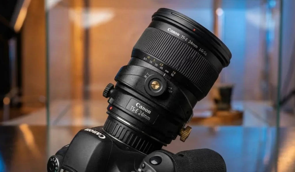 Tilt shift lens close up showing tilt and shift controls on a professional camera lens