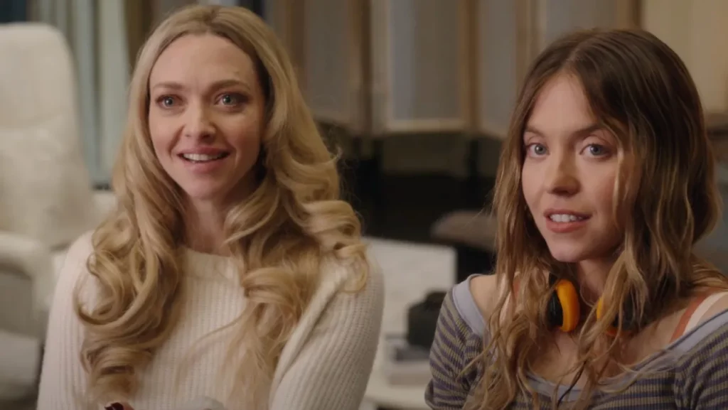 Two women standing together indoors with uneasy expressions, suspenseful scene from The Housemaid film adaptation