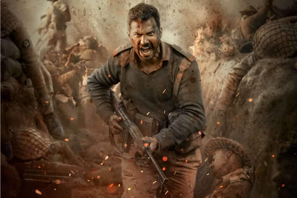 Border 2 war scene featuring varun dhawan as a soldier charging through battlefield explosions