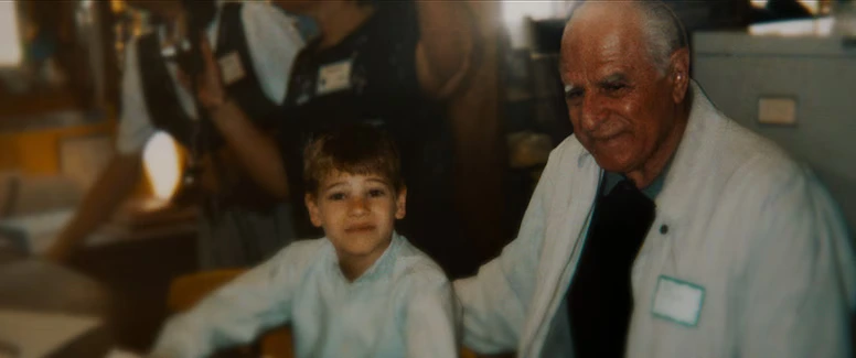 Archival family photo of John Chakalos sitting with his young grandson Nathan Carman, as seen in The Carman Family Deaths true story documentary.