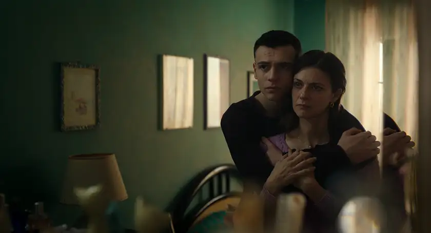 Francesco Gheghi as Luigi embracing his mother, played by Barbara Ronchi, in a tense and emotional scene from the Italian film Familia.