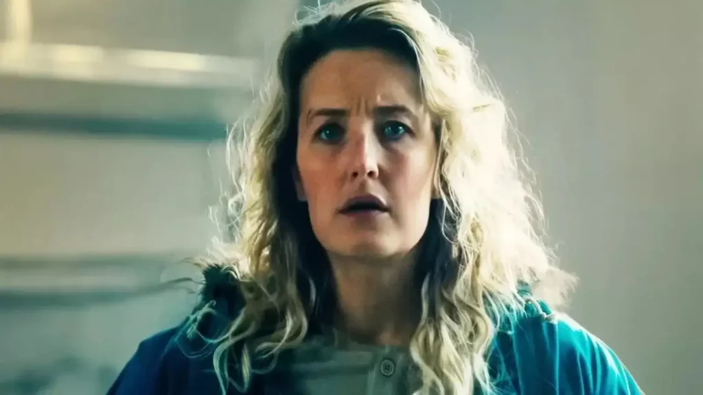 Paleontologist Nora Tidemann looking shocked in a scene from the Troll 2 movie sequel on Netflix, highlighting emotional character moments.