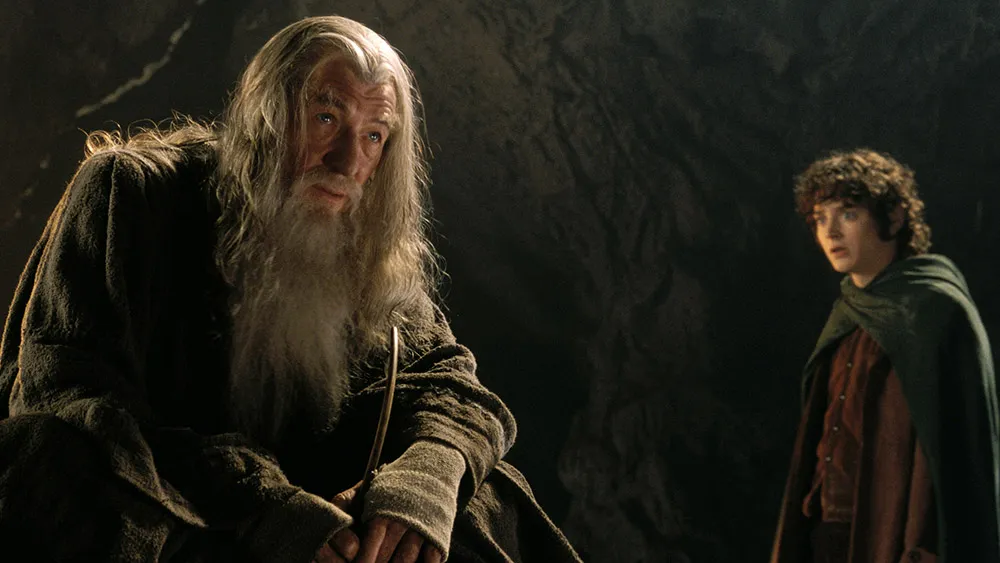 Epic Lord of the Rings scene featuring a wise wizard and a young hobbit in a dark Middle-earth cave during the trilogy’s cinematic journey
