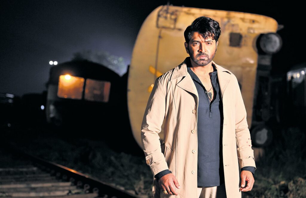 Retta Thala movie still featuring a rugged dual-role character in a dark action setting highlighting Tamil action thriller intensity