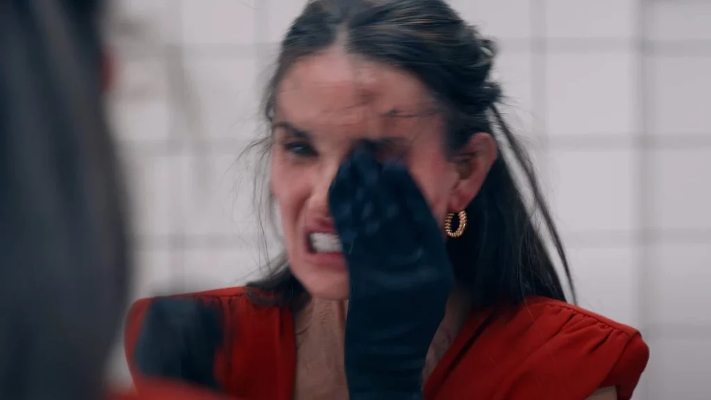 Disturbing transformation scene from The Substance (2024) showing raw body horror and emotional breakdown