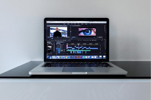AI video editing software timeline on laptop demonstrating shot division AI for automated scene breakdown and faster post-production