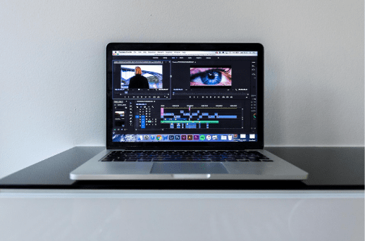 AI video editing software timeline on laptop demonstrating shot division AI for automated scene breakdown and faster post-production