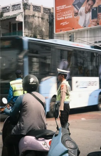 A camera moving alongside a character running through a busy street.