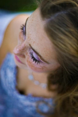 A close-up of a person's face, showing emotion while slightly revealing the background.