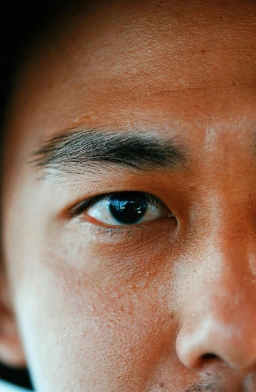 A detailed view of a person's face, emphasizing emotion through focused attention on the eyes.