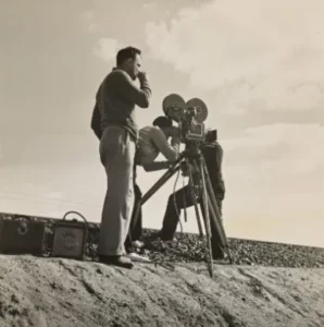 Director reviewing a film shooting schedule with a clipboard and pen