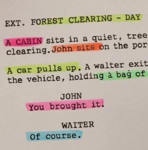 A close-up of a screenplay page with different colored highlighters marking specific production needs.