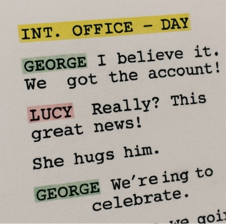 A close-up of a digital script page with different colored highlights automatically applied to character names and scene headings.